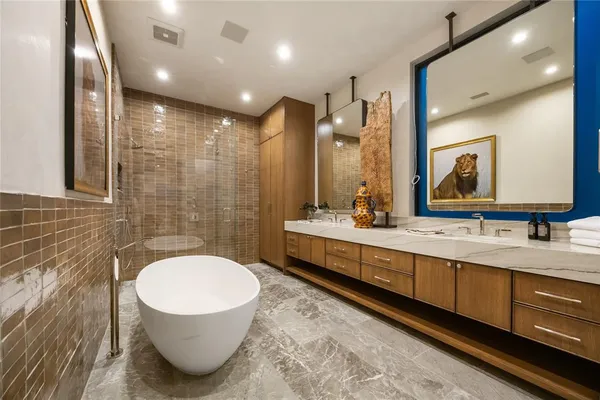 a bathroom with a sink a toilet a mirror and shower