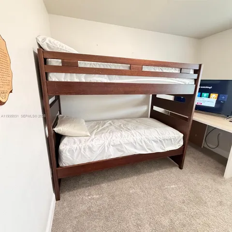 a bedroom with a bed and a chair