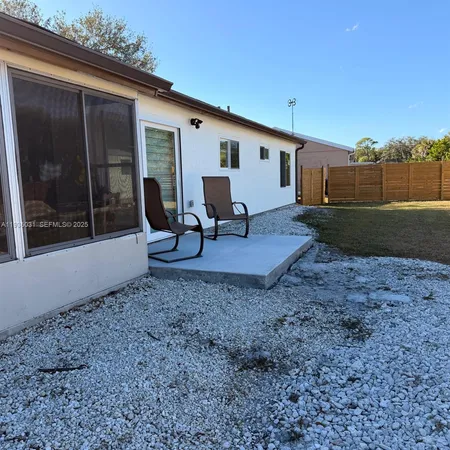 a view of a backyard with furniture and garden