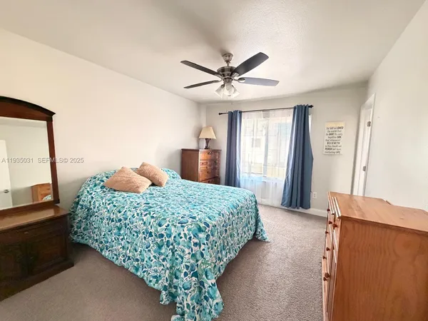 a bedroom with a bed and a large mirror