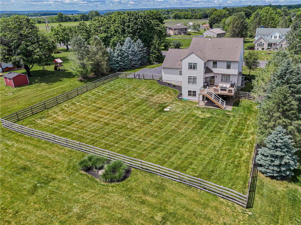 6000 Pond View Terrace Bath, PA 18014 - Photo 64 of 69 Fenced backyard with an elevated deck overlooking vast green spaces and distant landscapes.