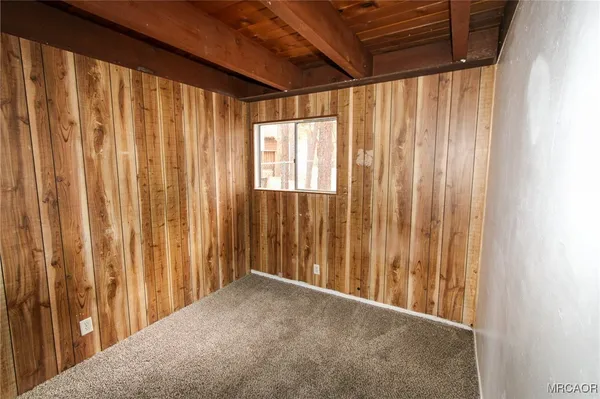 a view of a room with a wooden door and a curtain