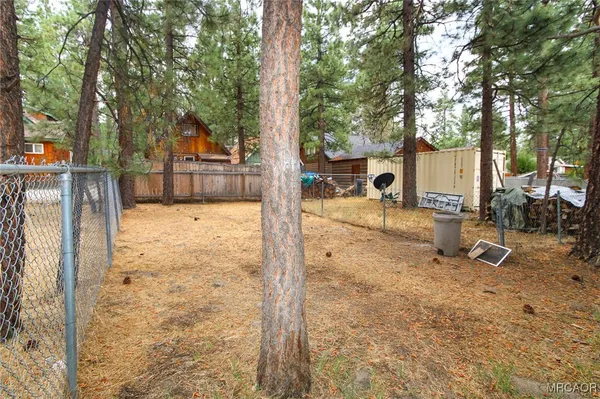 a view of a backyard house with large trees