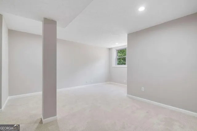 an empty room with windows and closet