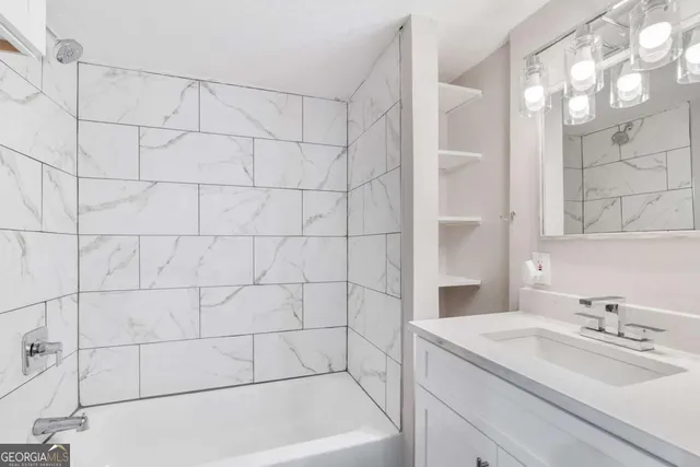 a bathroom with a sink and shower