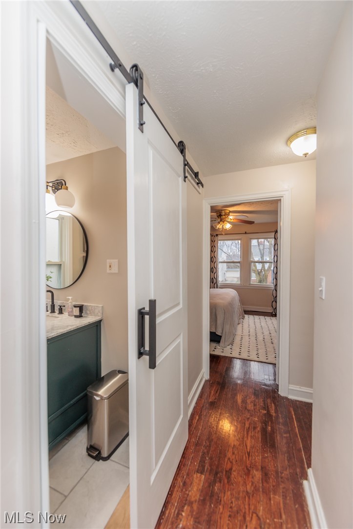 2199 Cranston Road Cleveland, OH 44118 - Photo 20 of 40 Corridor featuring dark wood-type flooring and a barn door
