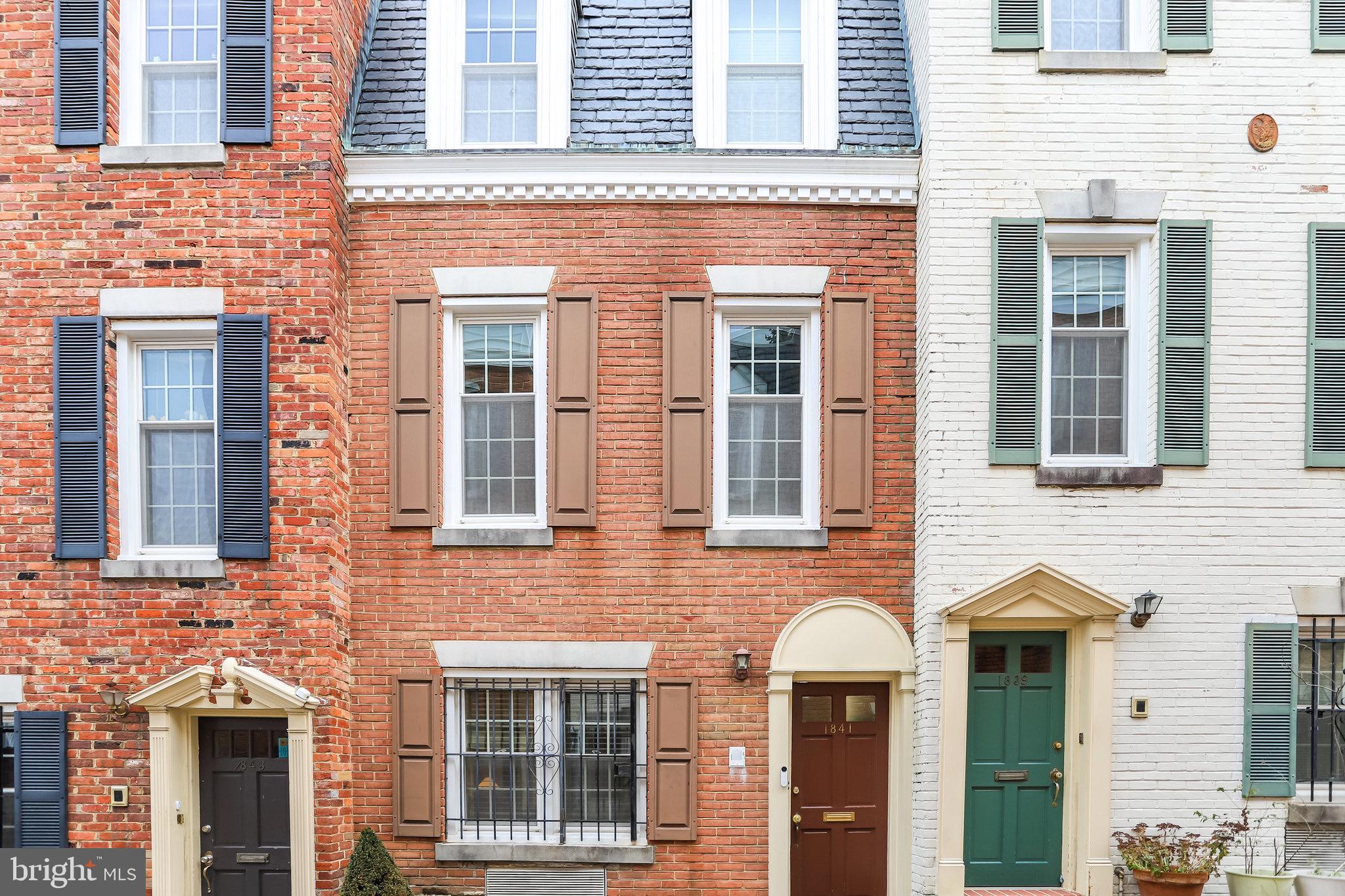 a front view of a brick house with a large windows