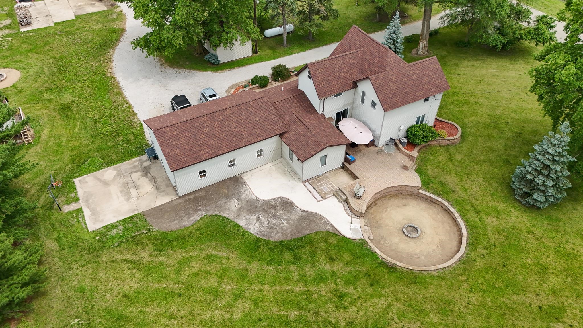 an aerial view of a house with garden space and street view