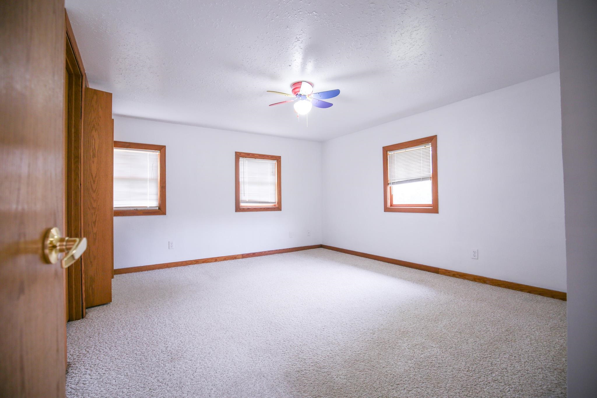 382 Keigwin Road Walnut, IL 61376 - Photo 24 of 68 an empty room with windows and fan