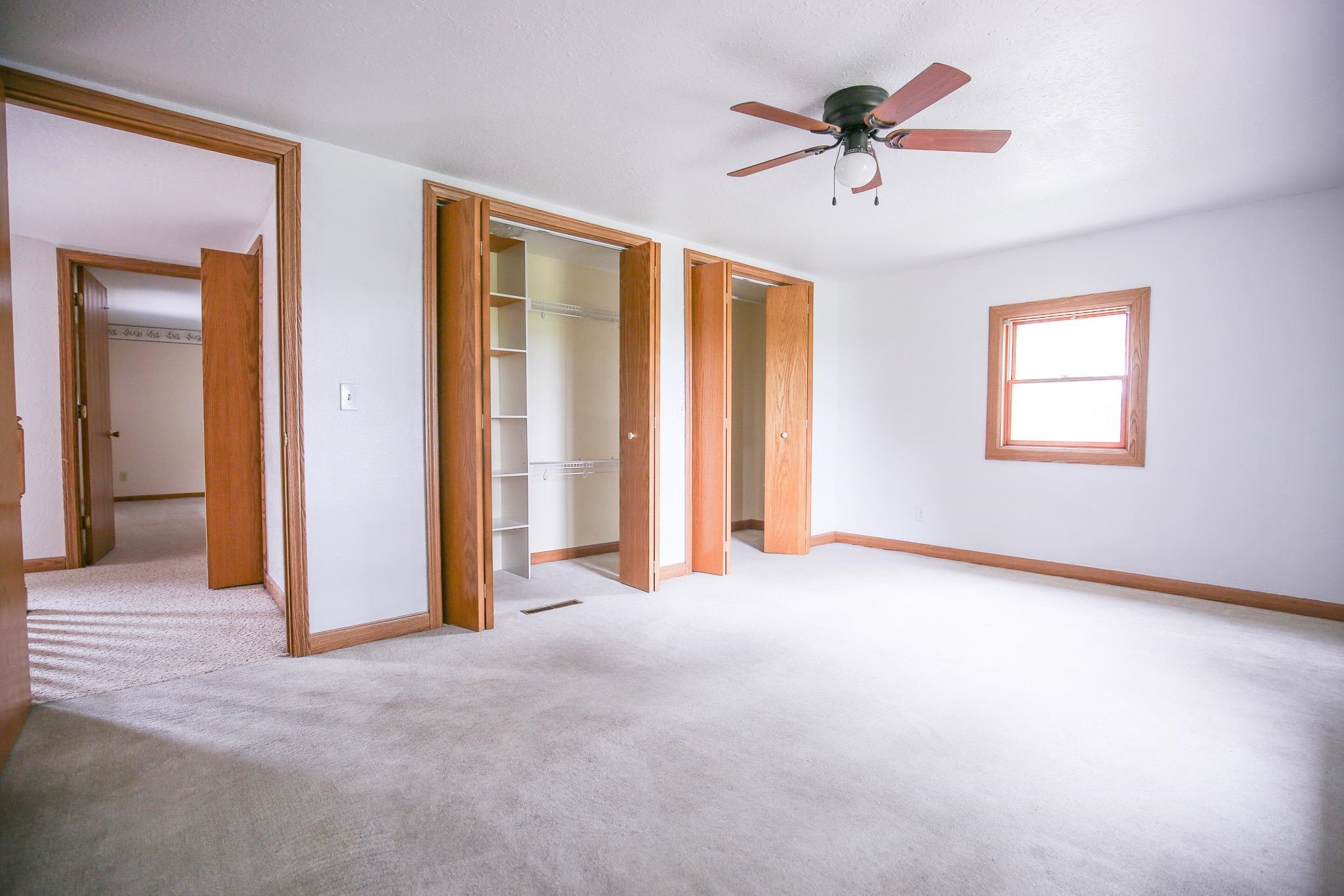 382 Keigwin Road Walnut, IL 61376 - Photo 27 of 68 an empty room with chandelier fan and windows