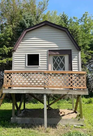 a front view of a house with a garden and plants