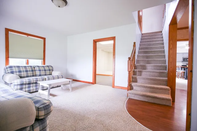 a front view of a house with a garden and trees