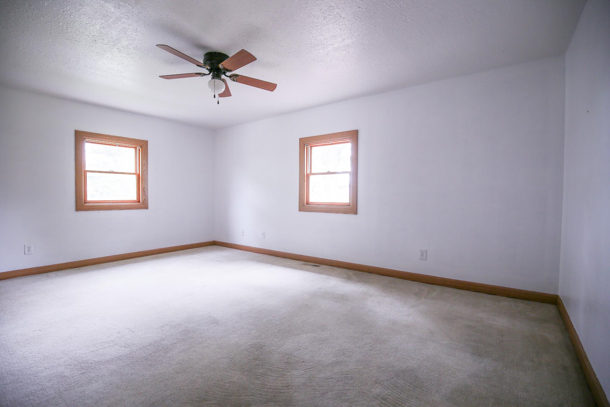 382 Keigwin Road Walnut, IL 61376 - Photo 30 of 68 an empty room with a window and a ceiling fan