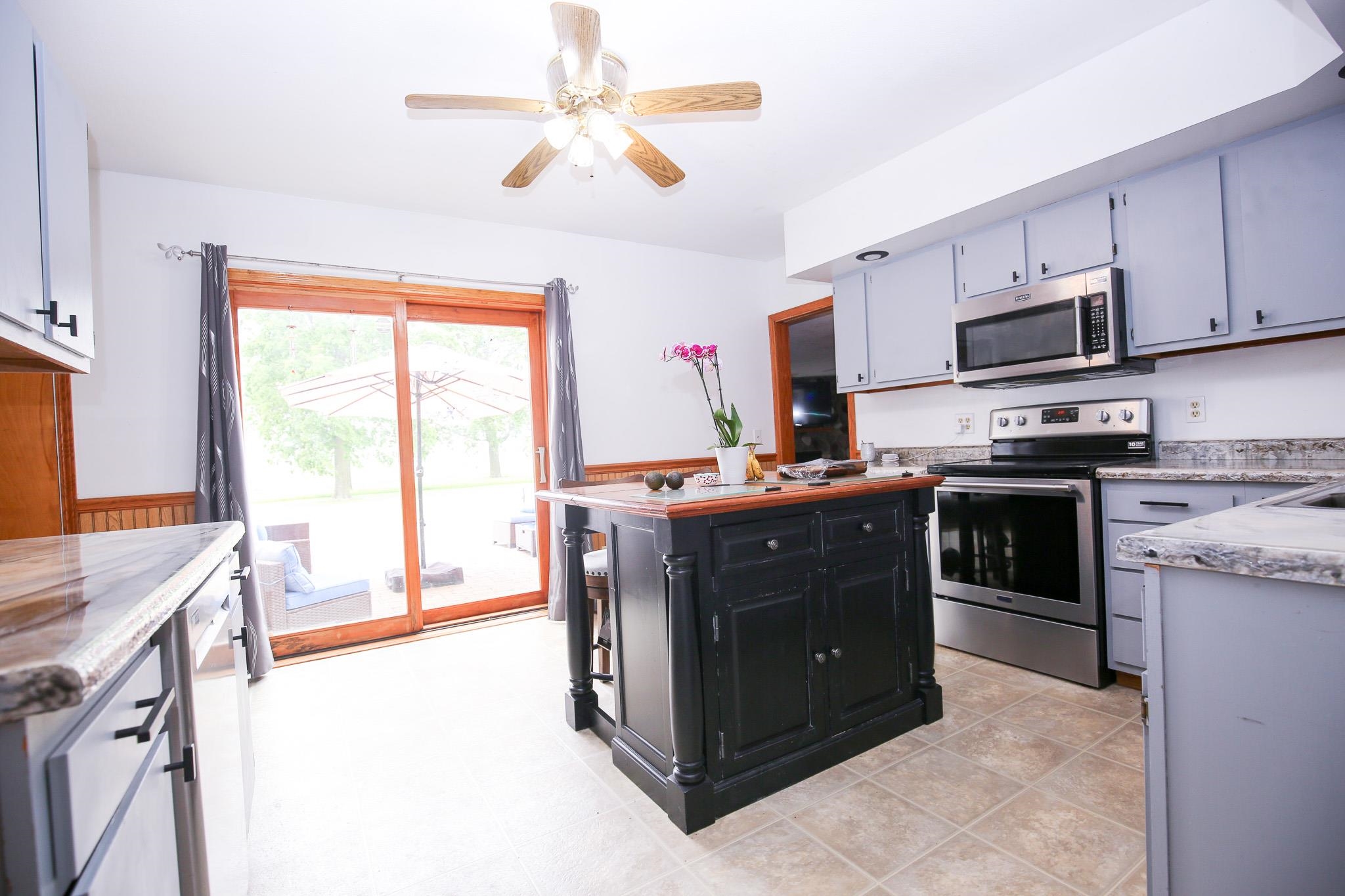 382 Keigwin Road Walnut, IL 61376 - Photo 41 of 68 a kitchen with stainless steel appliances granite countertop a stove and a sink
