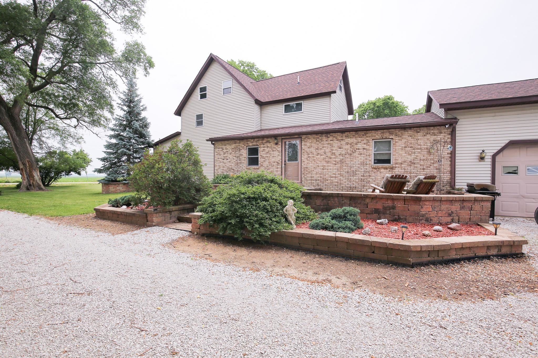 382 Keigwin Road Walnut, IL 61376 - Photo 49 of 68 a front view of a house with a garden and plants