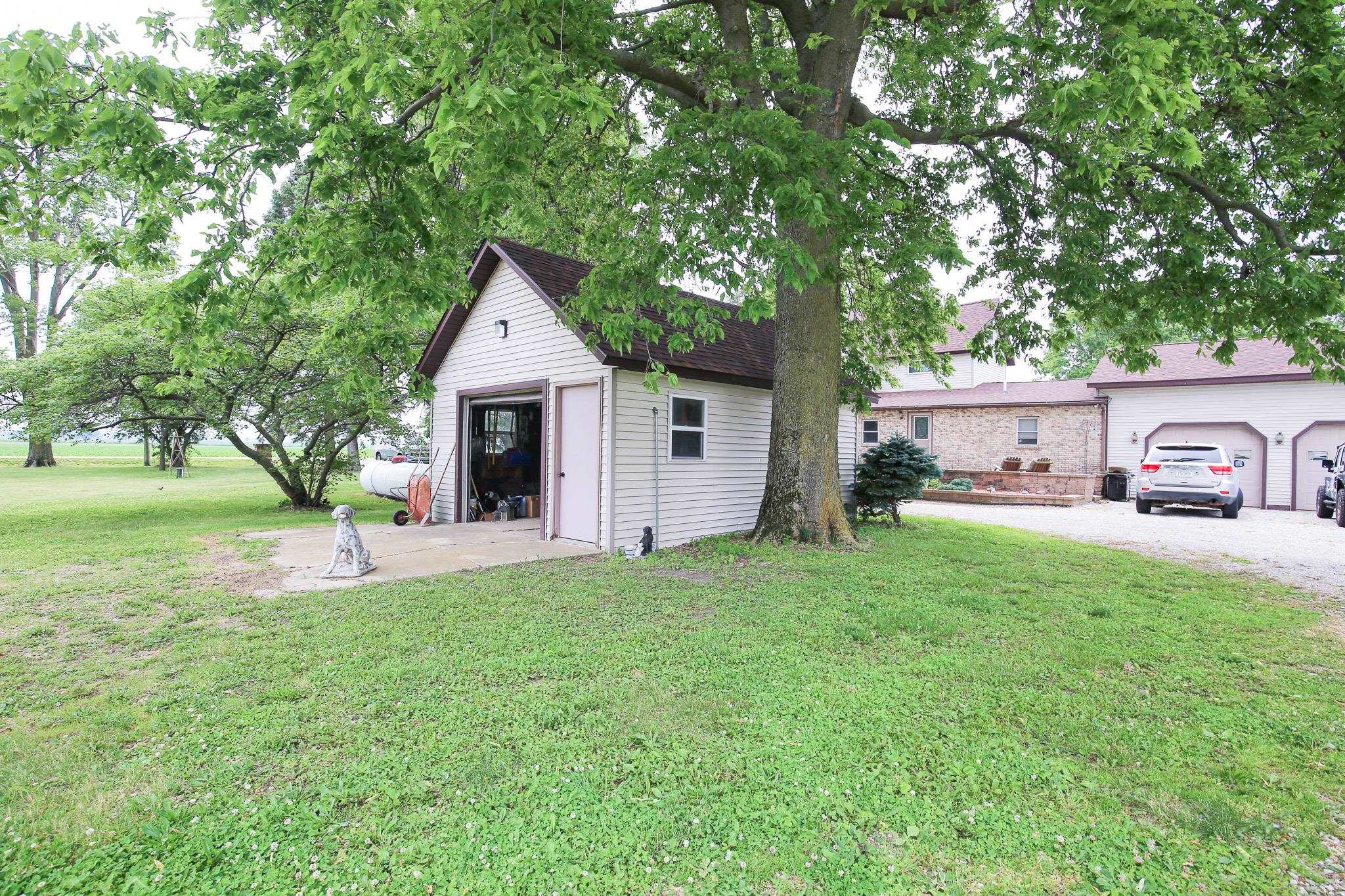 382 Keigwin Road Walnut, IL 61376 - Photo 50 of 68 a front view of a house with a garden and trees