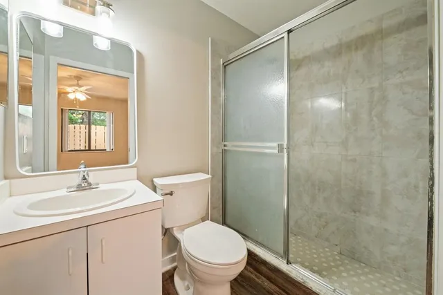 a bathroom with a sink toilet and shower