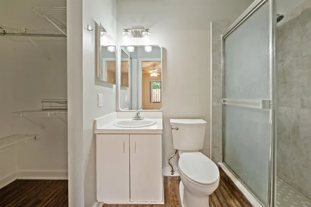 a bathroom with a toilet a sink and shower