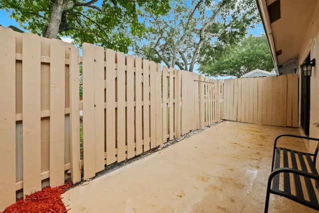 a view of a backyard with wooden fence