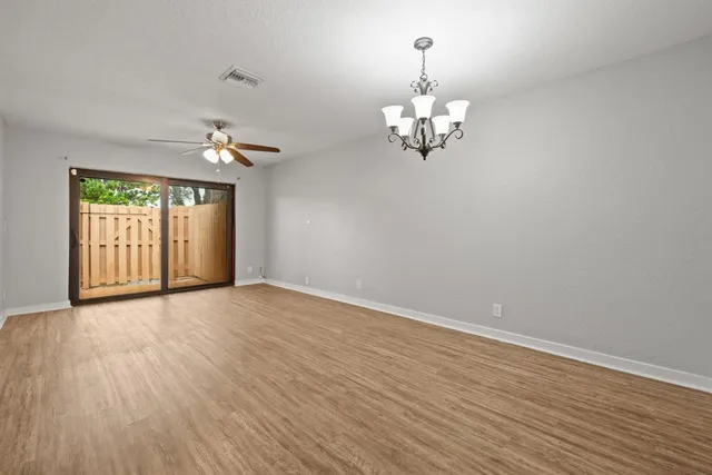 a view of an empty room with chandelier