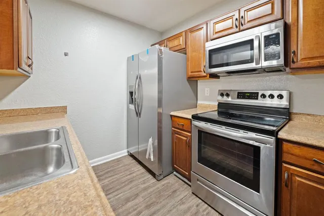a kitchen with a stove microwave and refrigerator