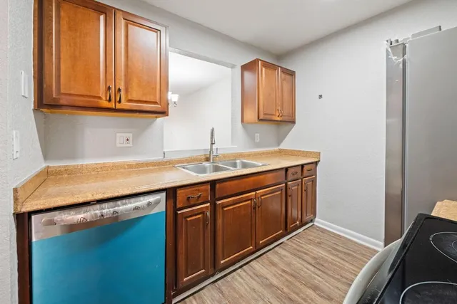 a utility room with wooden floor washer and dryer