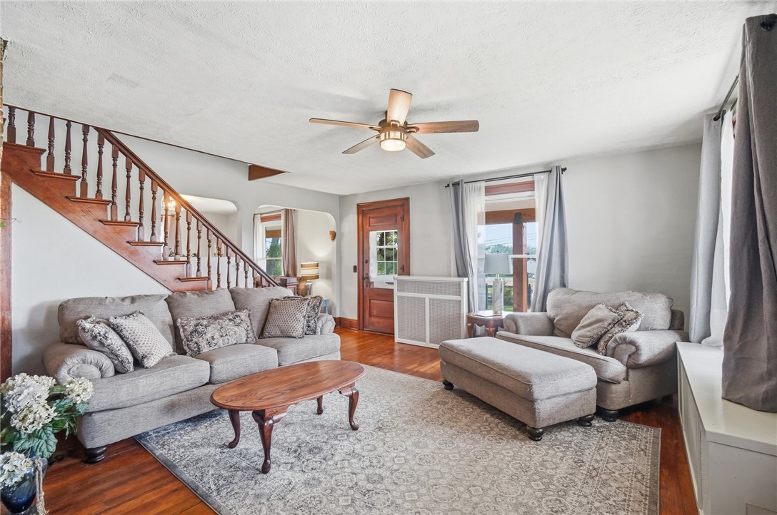 6155 North Union Road Clayton, OH 45315 - Photo 12 of 59 This inviting living area boasts rich hardwood flooring and a classic wooden staircase.
