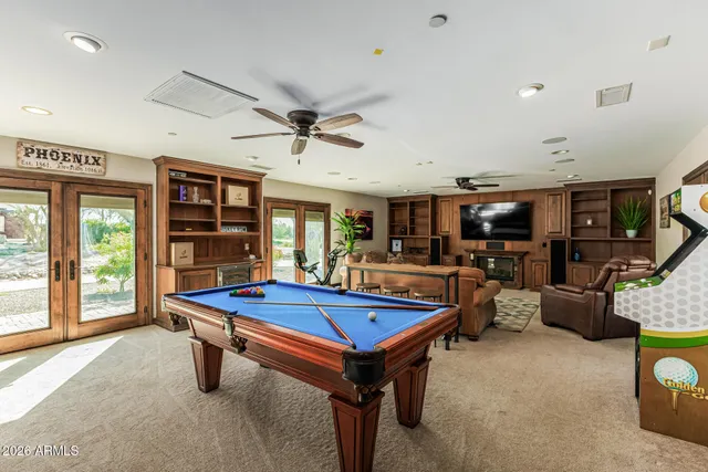 a bedroom with a large bed and a ceiling fan
