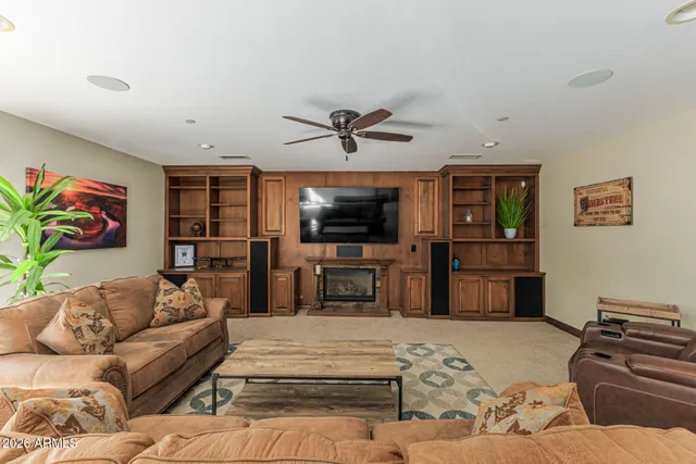 a bed room with a bed and a ceiling fan