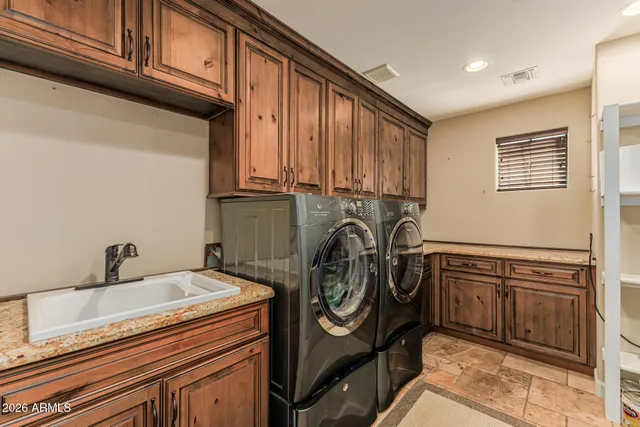 a bathroom with a granite countertop sink vanity mirror and toilet