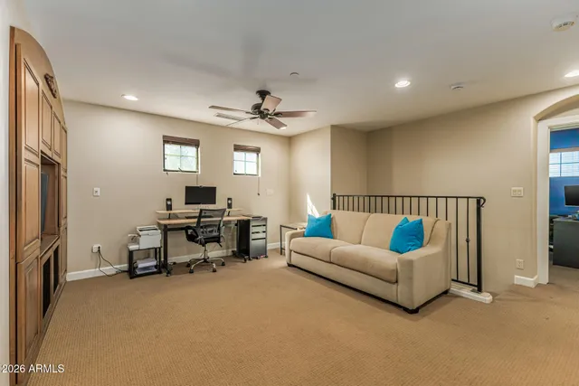 a spacious bedroom with a bed and large windows