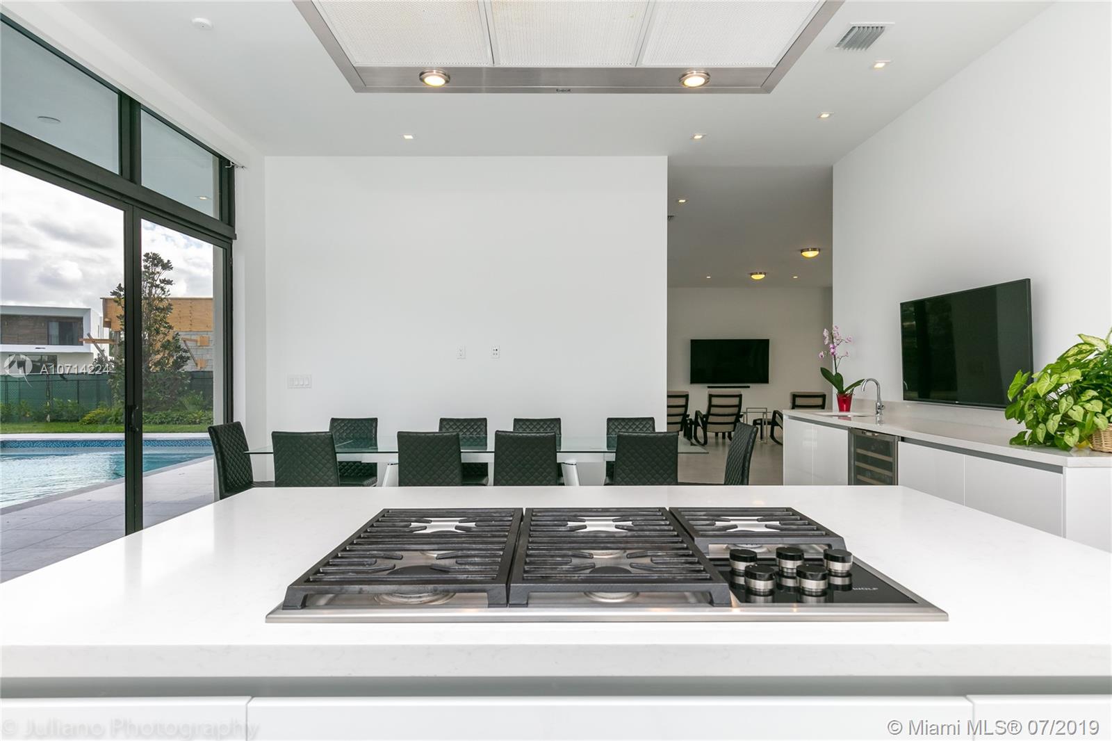 16630 Sunset Way Weston, FL 33326 - Photo 5 of 17 a large white kitchen with a large window