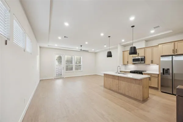 a kitchen with stainless steel appliances granite countertop a stove and a refrigerator