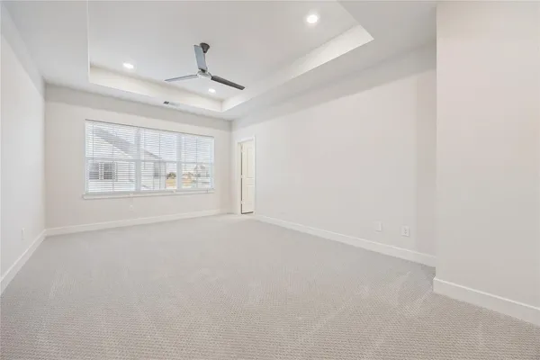 an empty room with windows and cabinet