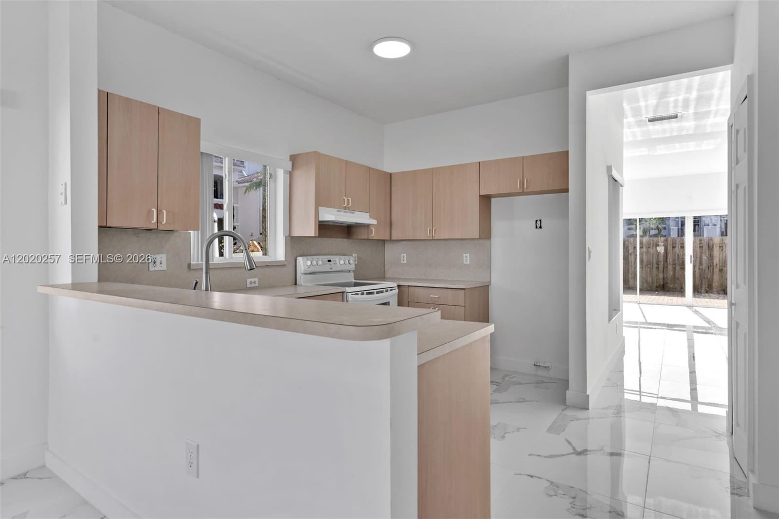 10245 Southwest 154th Place, Unit 1123 Miami, FL 33196 - Photo 18 of 38 a kitchen with appliances a sink and cabinets