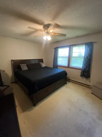 a bedroom with a bed and with furniture
