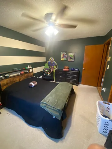 a room with gym equipment and wooden floor