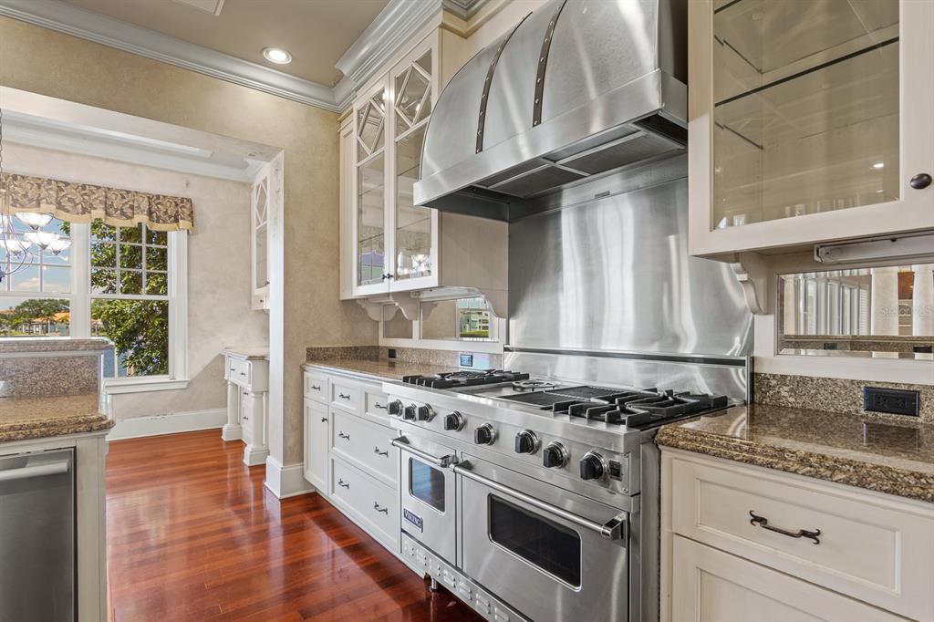 1029 Royal Pass Road Tampa, FL 33602 - Photo 23 of 68 a kitchen with granite countertop stainless steel appliances a stove sink and cabinets