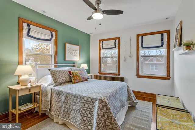 a bedroom with a bed and a painting on the wall