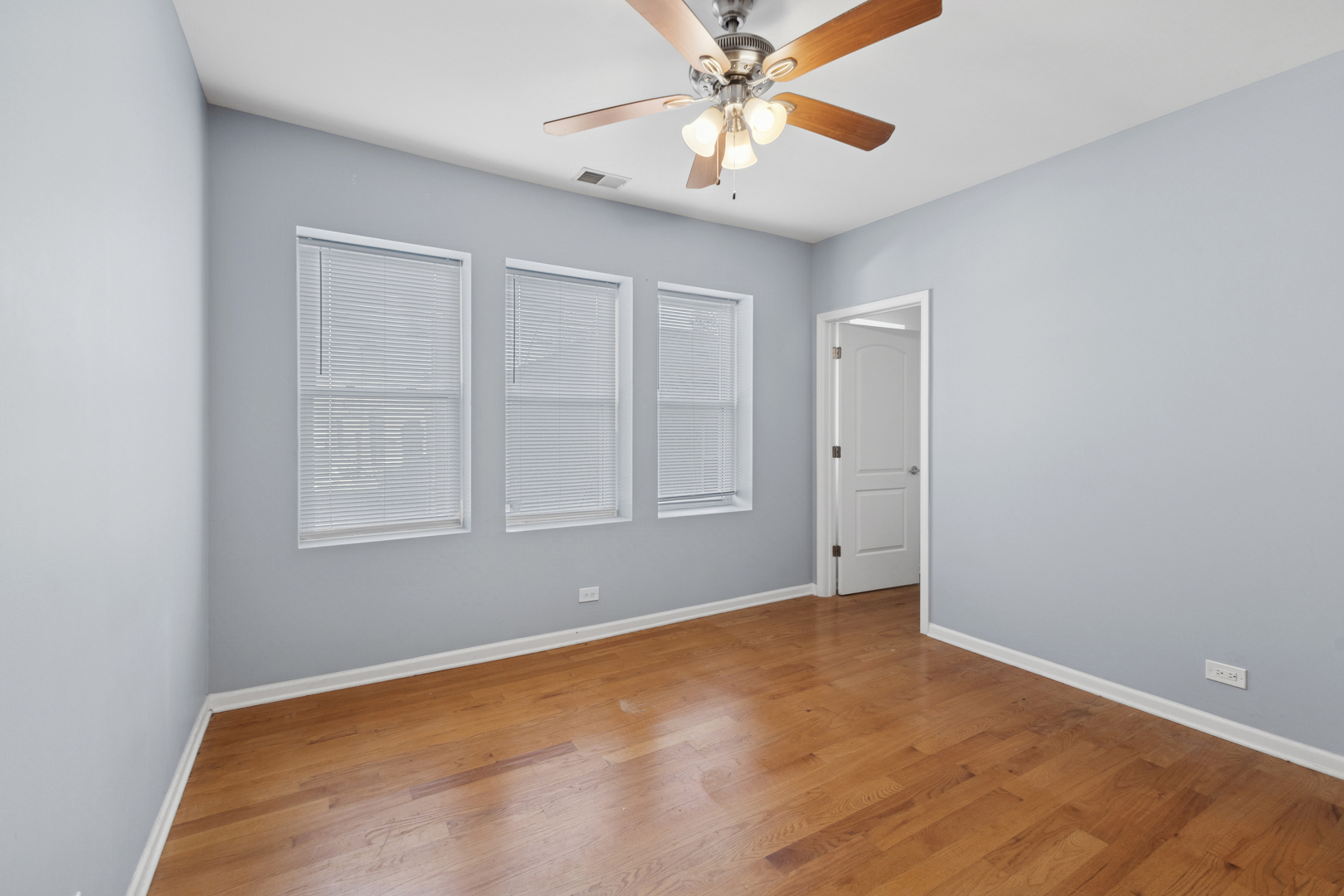 9222 South Laflin Street, Unit 2N Chicago, IL 60620 - Photo 7 of 14 an empty room with windows and fan
