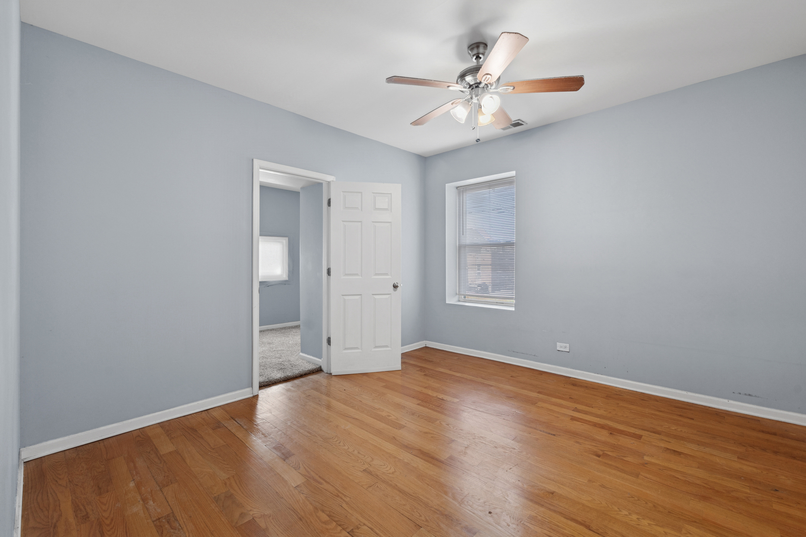 9222 South Laflin Street, Unit 2N Chicago, IL 60620 - Photo 8 of 14 wooden floor in an empty room