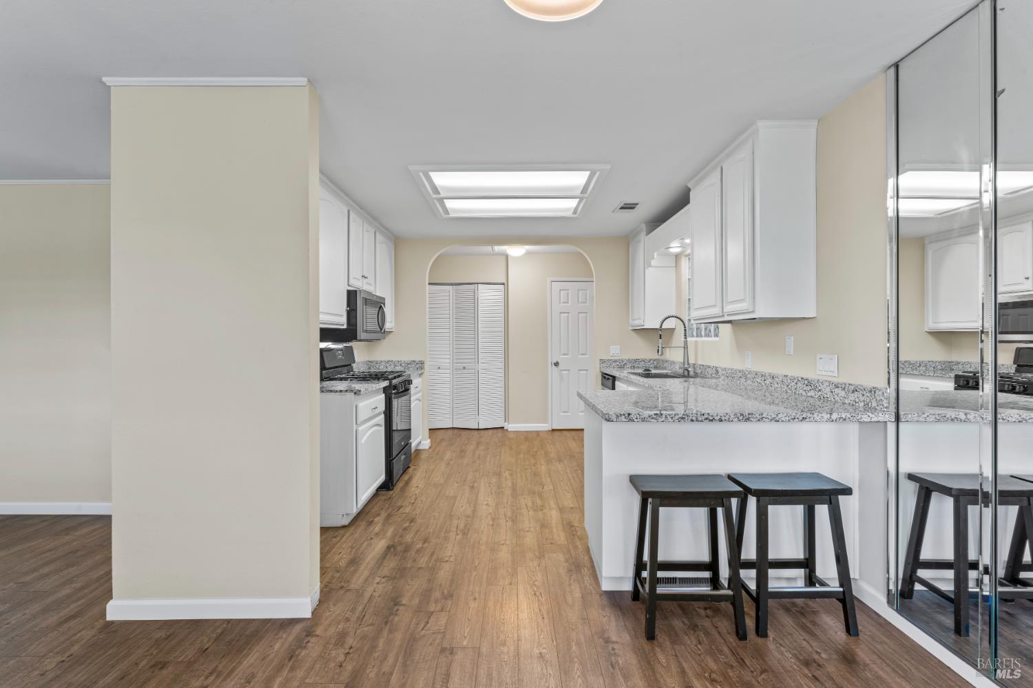 210 Trinity Court Rio Vista, CA 94571 - Photo 12 of 38 a kitchen with granite countertop white cabinets and stainless steel appliances
