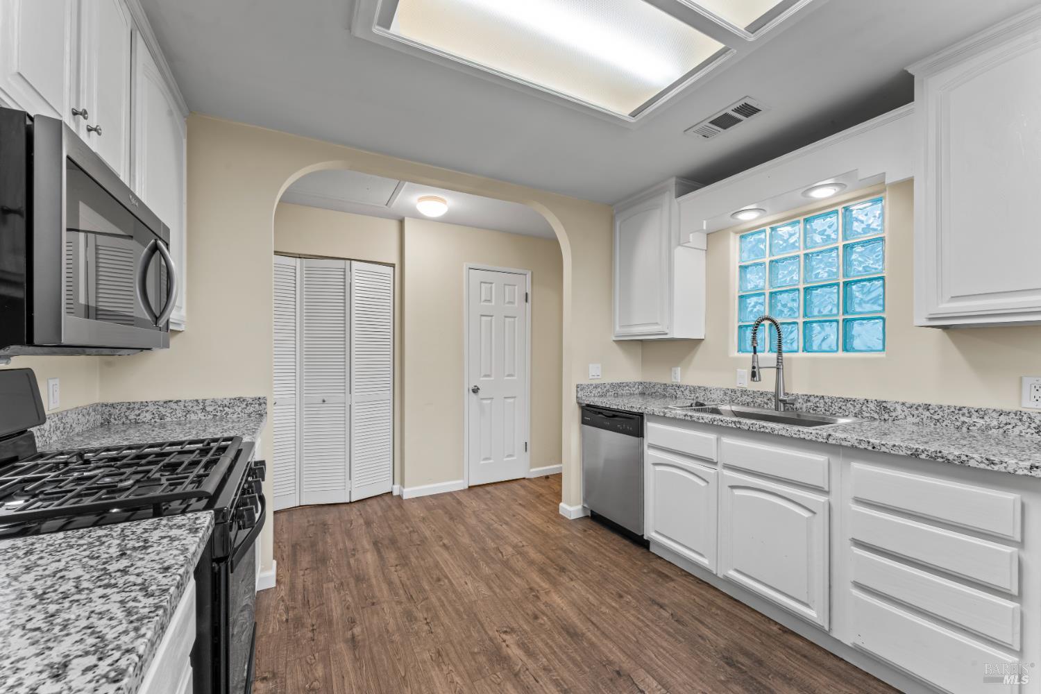 210 Trinity Court Rio Vista, CA 94571 - Photo 13 of 38 a kitchen with granite countertop a sink stainless steel appliances and cabinets