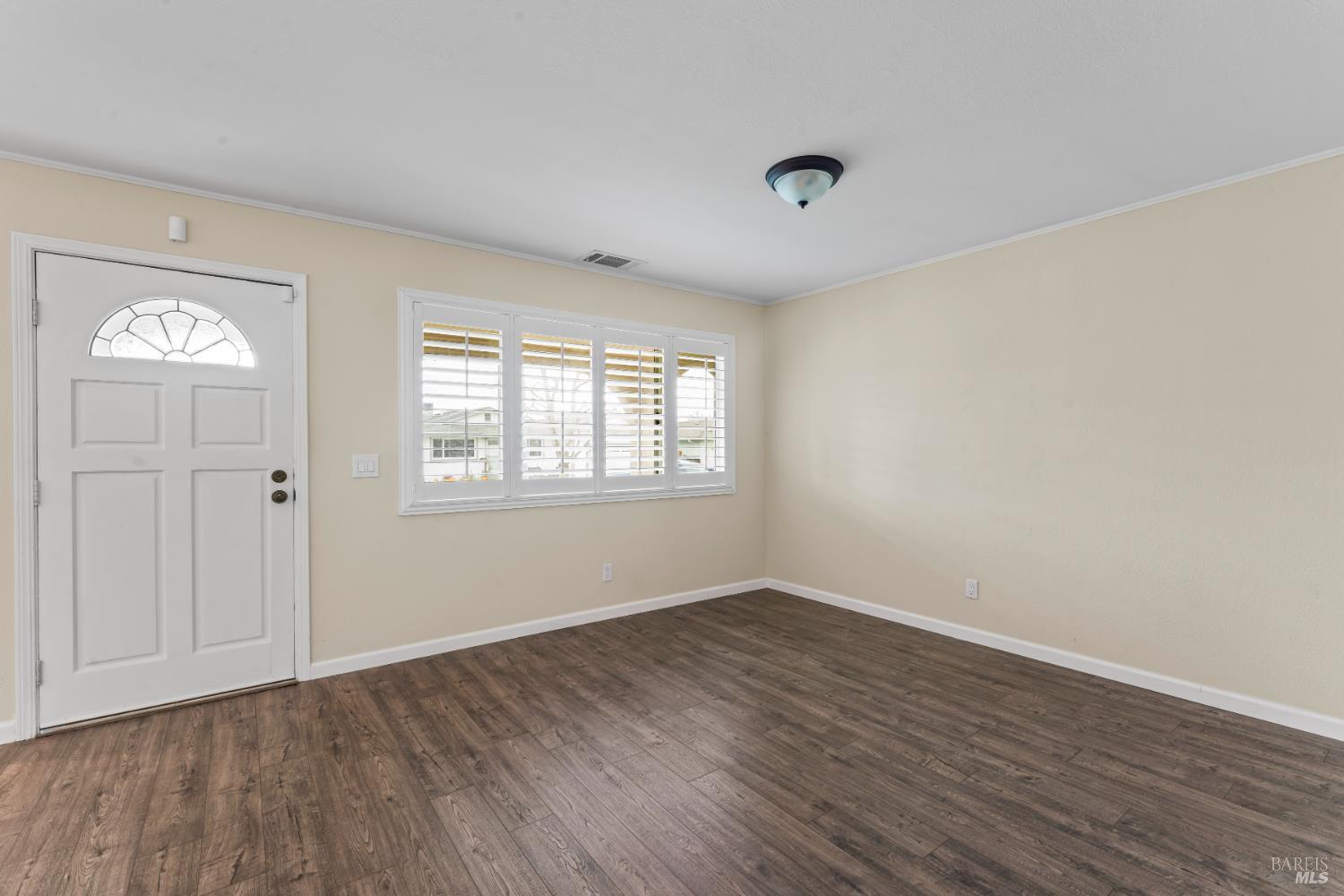 210 Trinity Court Rio Vista, CA 94571 - Photo 4 of 38 a view of an empty room with wooden floor and a window