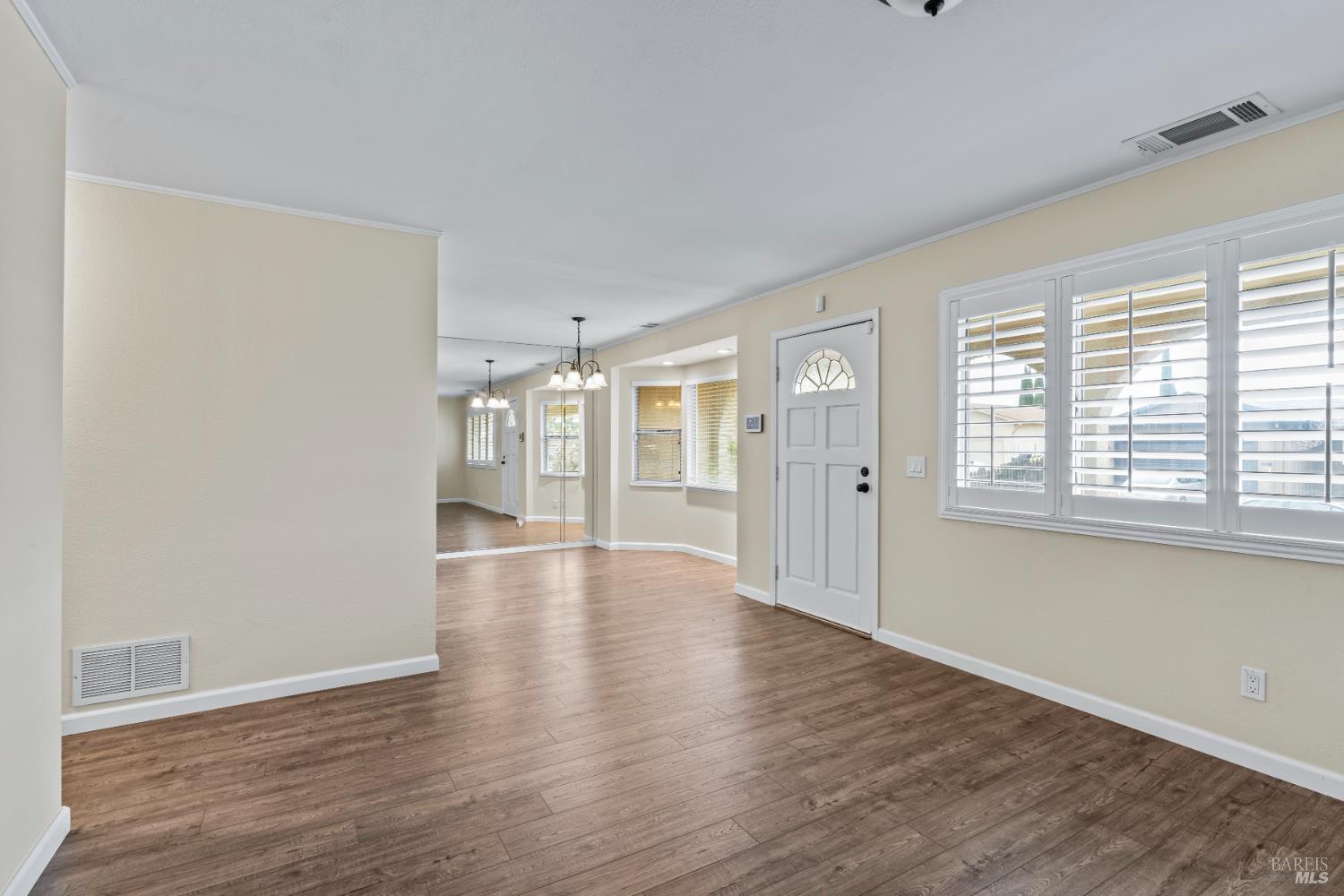 210 Trinity Court Rio Vista, CA 94571 - Photo 5 of 38 a view of an empty room with wooden floor and a window