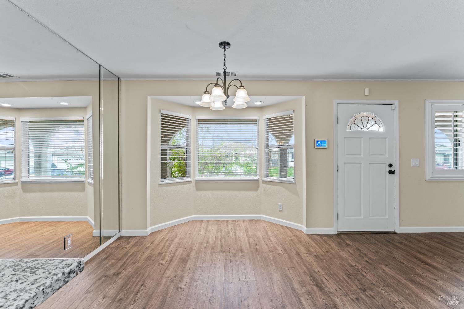 210 Trinity Court Rio Vista, CA 94571 - Photo 10 of 38 a big room with wooden floor a chandelier and windows
