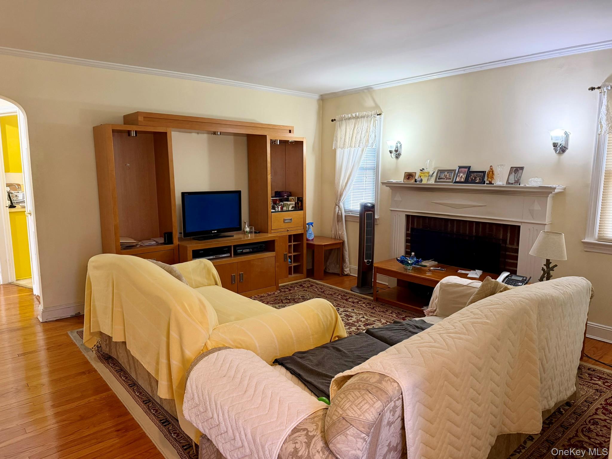 586 Stratford Road Baldwin, NY 11510 - Photo 3 of 24 Living Room with Wood-Burning Fireplace & Wood Floors