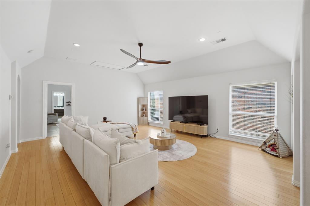 3315 Ricci Lane Irving, TX 75062 - Photo 20 of 40 Vaulted ceiling with recessed lighting, wood-finish flooring, ceiling fan, and multiple windows with blinds