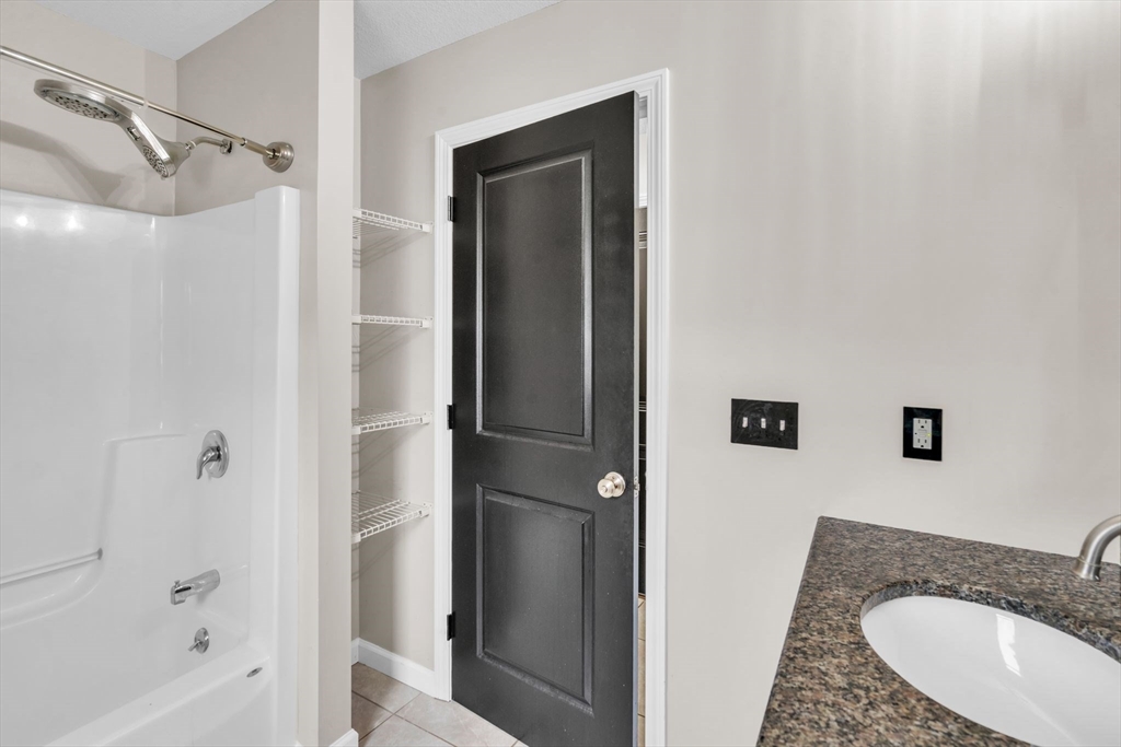 25 Thomas Street Chicopee, MA 01013 - Photo 14 of 36 a bathroom with a granite countertop sink and a mirror