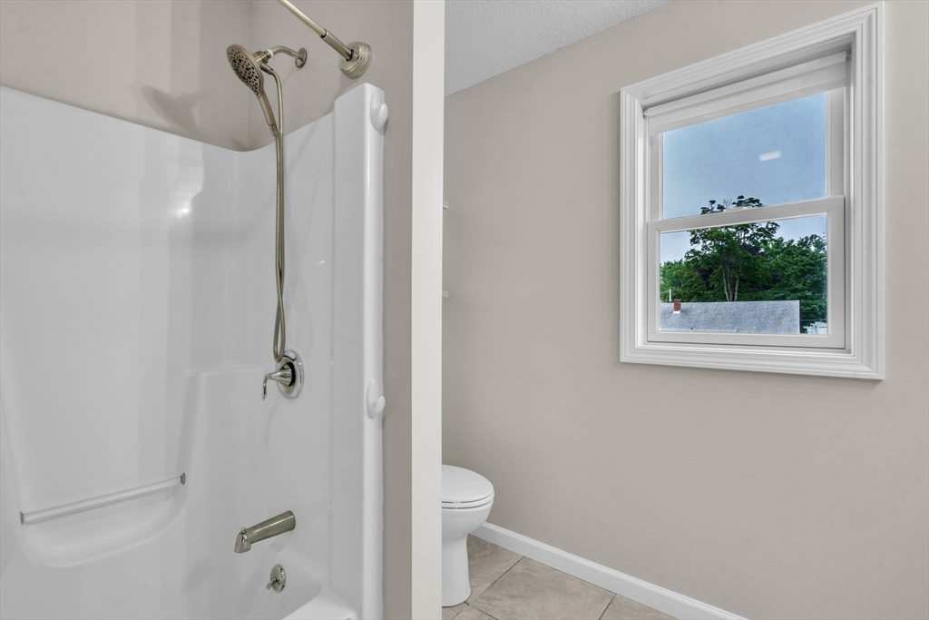 25 Thomas Street Chicopee, MA 01013 - Photo 15 of 36 a bathroom with a granite countertop sink a toilet and shower